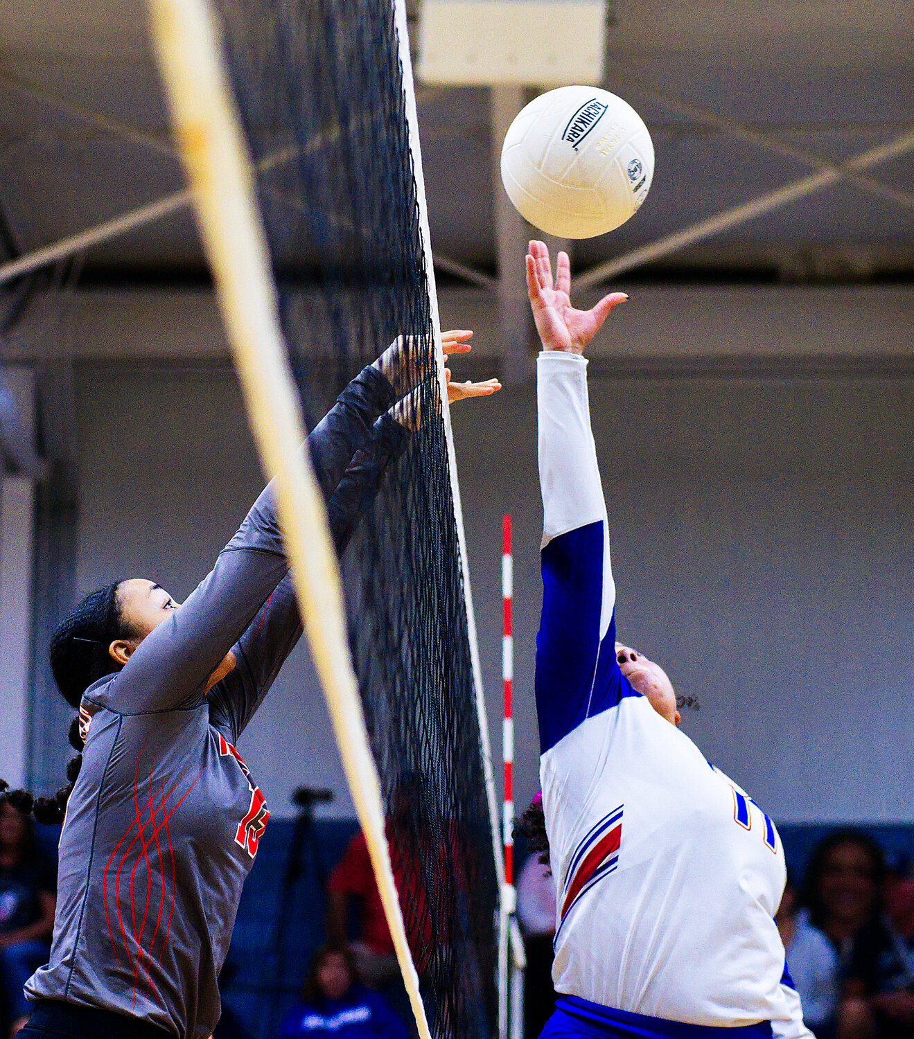 Kyra Jackson of Mineola and Ashley Davis of Quitman reach to control the ball at the net. [view more volleyball]